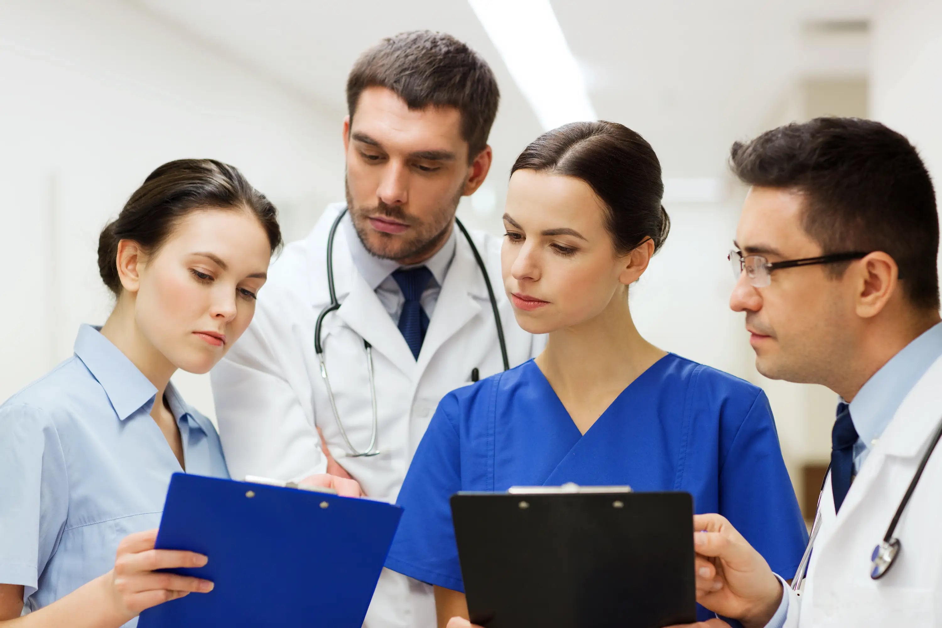 Group of medical professionals reviewing documents together.