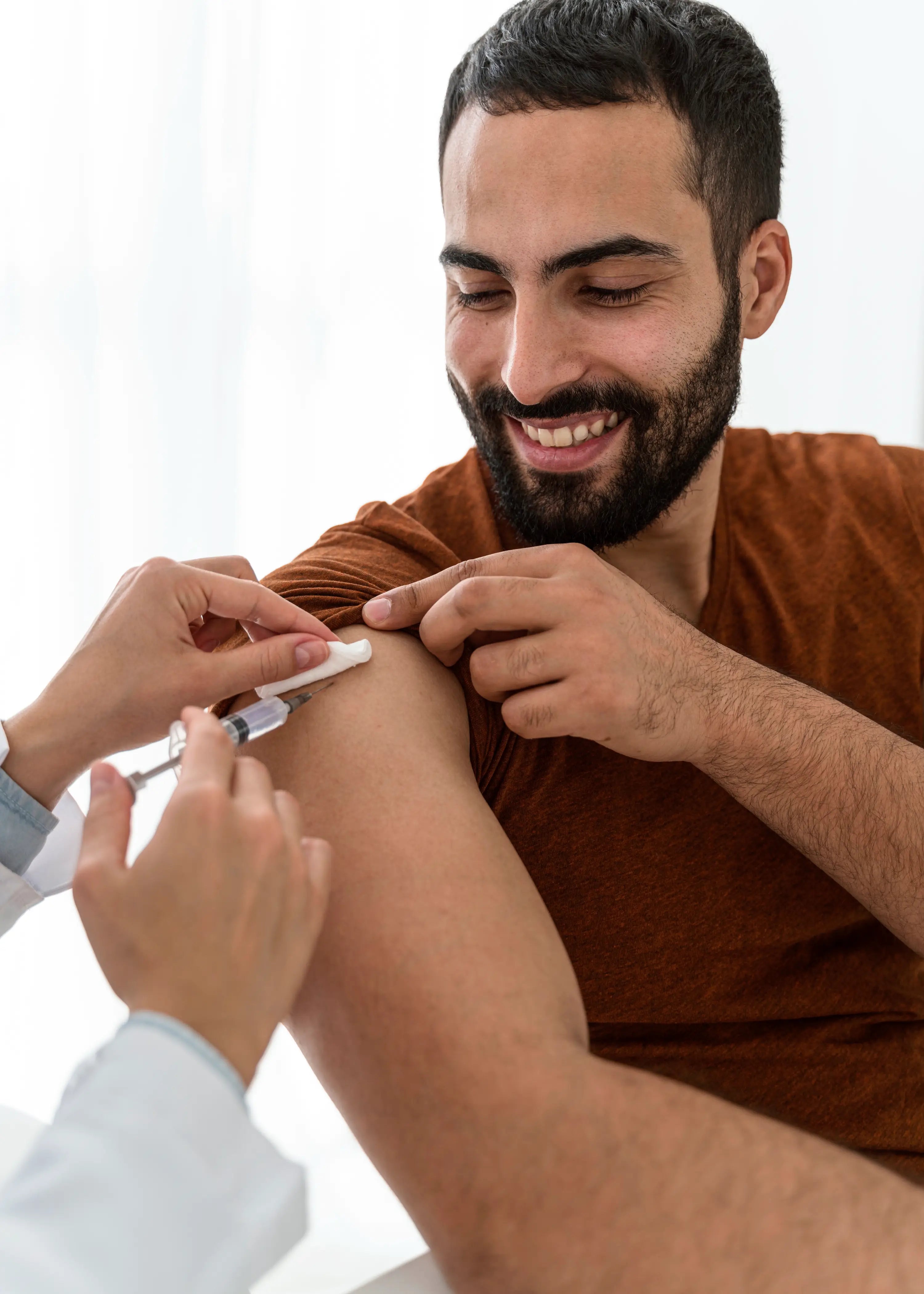 Person receiving a vaccine injection from a healthcare professional.