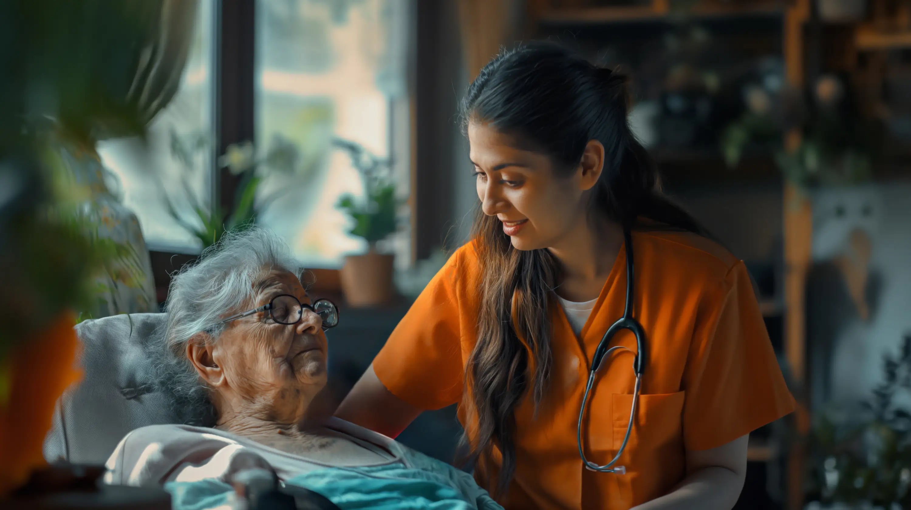 Nurse in orange uniform interacting with an elderly patient in a home setting.