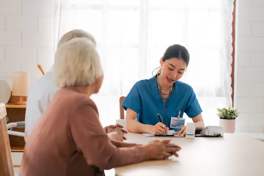 Nurse consulting with elderly patients at home, providing personalized healthcare services