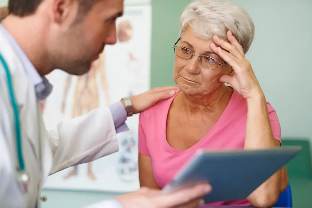 Doctor providing support to a concerned senior woman, addressing health challenges and care options for seniors