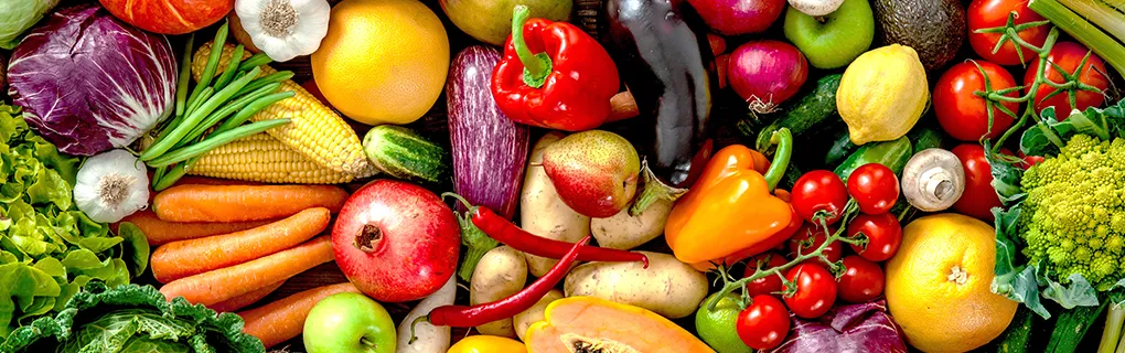 Colorful assortment of fresh fruits and vegetables arranged together.